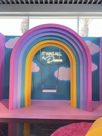 a room with a rainbow arch and a swing